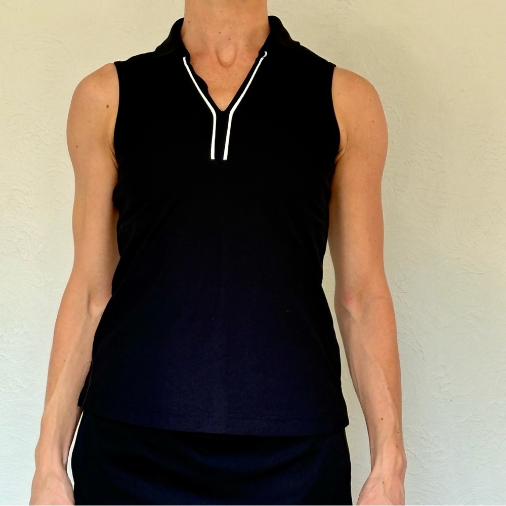 Black, sleeveless polo shirt with white details, perfect for #golf or #tennis